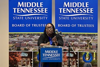 Dr. Stevens standing at podium