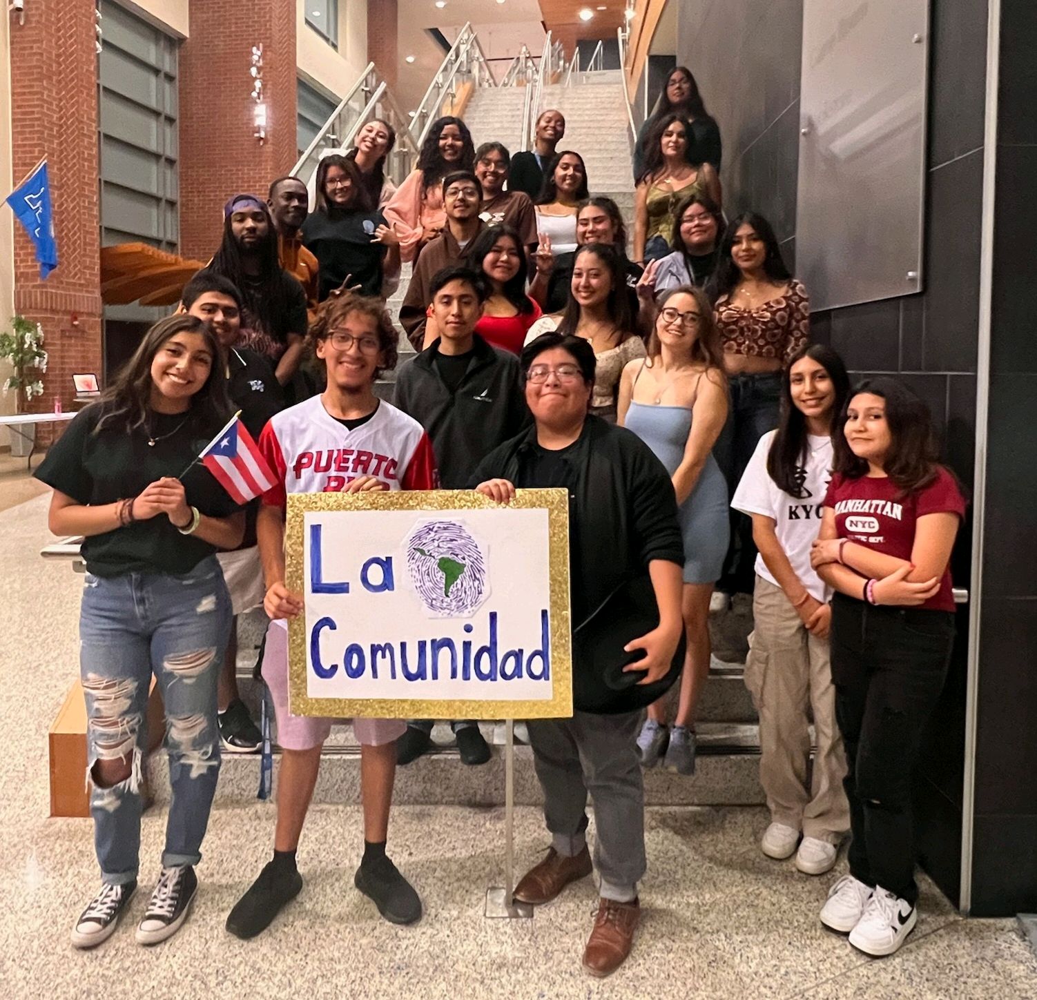 La Comunidad members posing on stairs